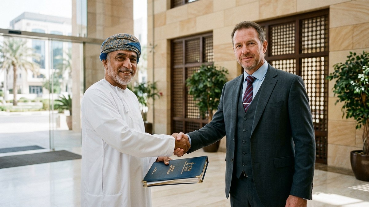 Omani Chartered Accountant and corporate client executive shaking hands in a Muscat office lobby after a successful SPF and statutory payroll audit